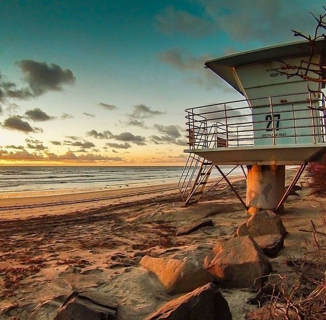 sea, water, beach, sky, horizon over water, shore, built structure, architecture, sunset, sand, building exterior, cloud - sky, nature, scenics, tranquility, tranquil scene, cloud, beauty in nature, outdoors, no people