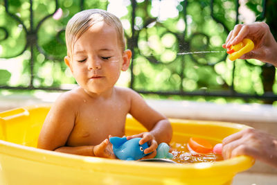 Mother bathing daughter