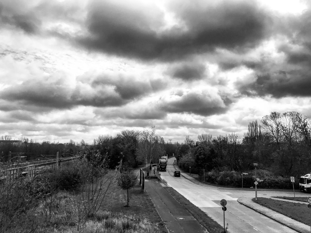 ROAD AMIDST TREES AGAINST SKY