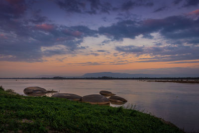 Scenic view of lake against sky during sunset