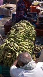 Rear view of man for sale at market stall
