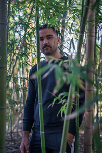 Moroccan man standing in the middle of a bamboo forest in morocco