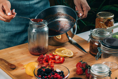 Midsection of man preparing food at table