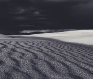 Scenic view of beach against cloudy sky