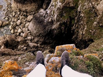 Low section of man standing on rock formation