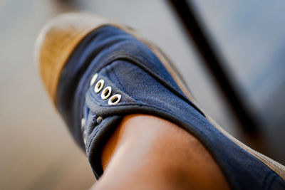 Low section of person wearing canvas shoes