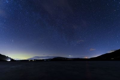 Scenic view of mountains against sky at night