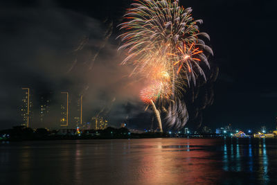 Low angle view of firework display at night