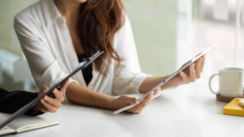 Midsection of businesswoman working at office