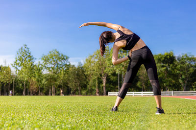 Full length of young woman in park