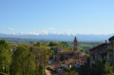 High angle view of buildings and trees against sky