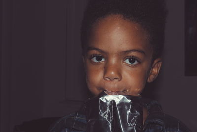 Close-up portrait of boy drinking juice at home