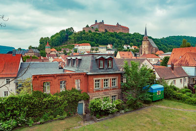 Buildings in town against sky