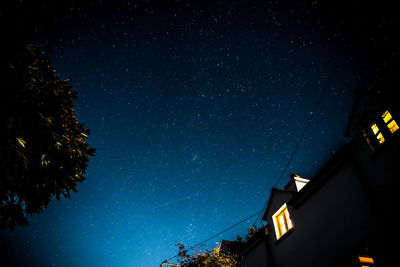 Low angle view of silhouette trees against sky at night