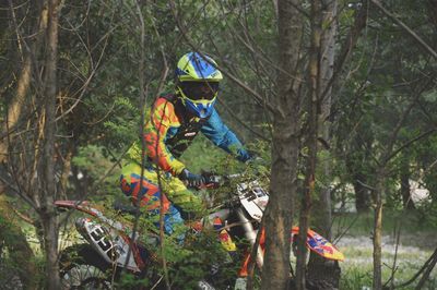 Man riding bicycle in forest