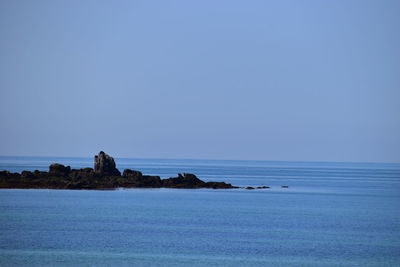 Scenic view of sea against clear blue sky