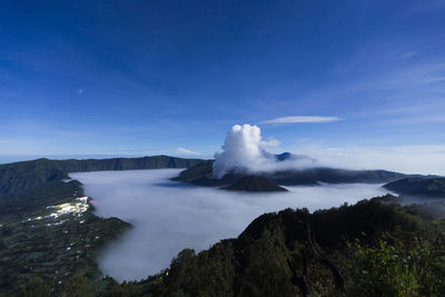 Scenic view of volcanic mountain against blue sky