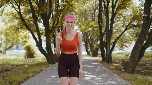 Portrait of young woman standing in park