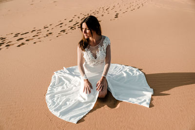 Young woman on sand dune in desert