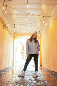 Full length of woman standing in building