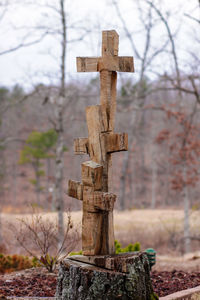 Close-up of cross on cemetery against sky