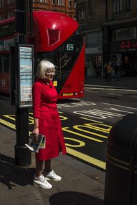 Full length of man standing on road in city