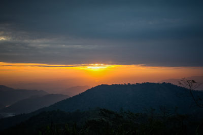 Scenic view of mountains against dramatic sky