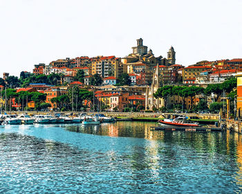 River and townscape against clear sky