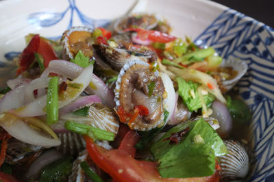 Cockles salad / hot and spicy shellfish blood cockles salad mix vegetable tomato herb and spices , 