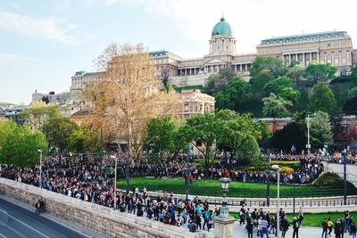 People at town square with city in background