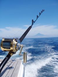 Close-up of fishing rod on ship in sea