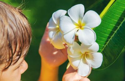 Midsection of woman holding flower