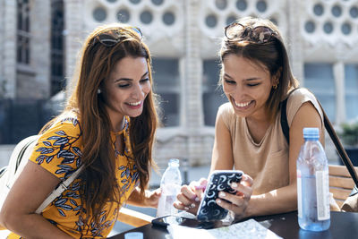 Happy young woman looking away outdoors