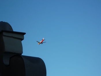 Low angle view of airplane flying in sky