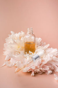 Drop oil serum collagen moisturizer for face soft light background.