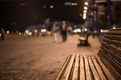 Surface level view of illuminated street in city at night