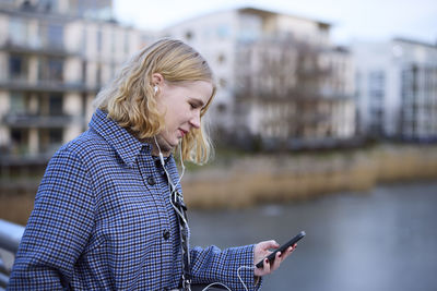 Smiling woman using cell phone