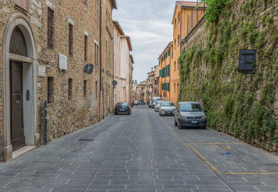 Cars on street amidst buildings in city