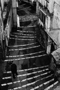 High angle view of woman walking up stairs