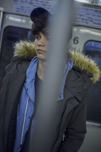 Young man standing at train