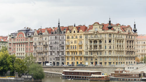 Buildings in city against cloudy sky