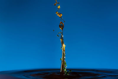 Close-up of electric lamp against clear blue sky