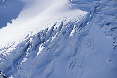 Scenic view of snow covered mountains against sky