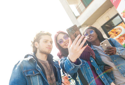 Portrait of young couple photographing