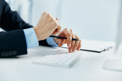 Cropped image of businessman using computer keyboard