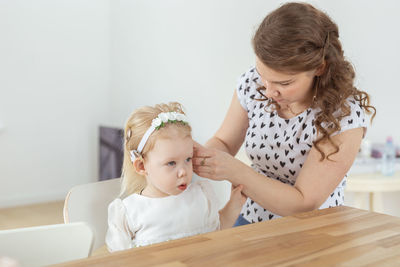 Mother assisting deaf daughter