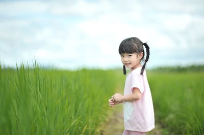 Cute girl standing in field