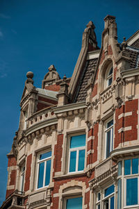 Low angle view of old building against blue sky