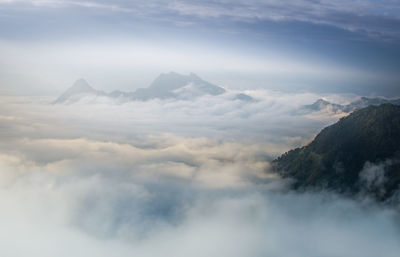 Scenic view of cloudscape mountains against sky