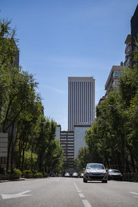 Sunny day in madrid city downtown with business buildings and cars in the background. 